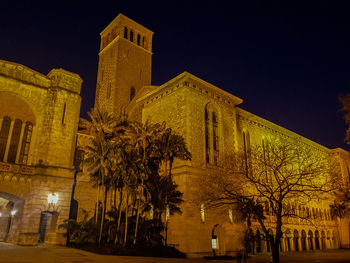 Low angle view of illuminated building at night