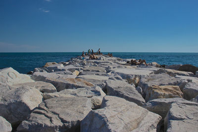 Rocks on beach against sky