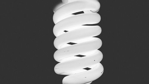 Low angle view of light bulbs hanging from ceiling
