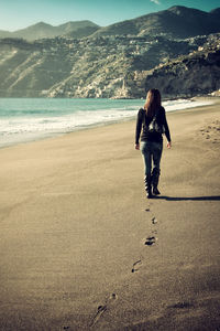 Full length of woman standing on beach