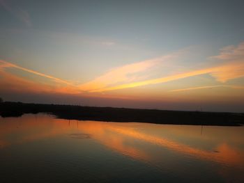 Scenic view of lake against sky during sunset