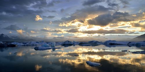 Scenic view of lake against sky during sunset