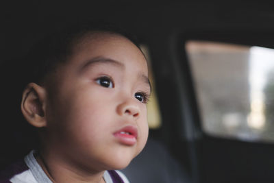 Portrait of cute baby girl in car