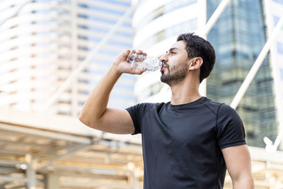 Full length of a man drinking glass