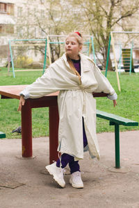 Full length of boy standing against tree