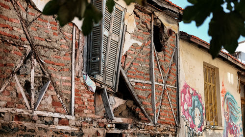 Low angle view of weathered wall of old building