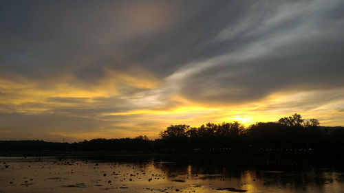 Scenic view of lake against orange sky