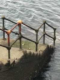 Close-up of railing against sea