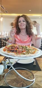 Woman sitting on table at restaurant