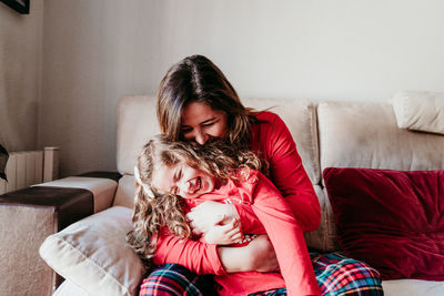 Happy mother and daughter spending leisure time at home