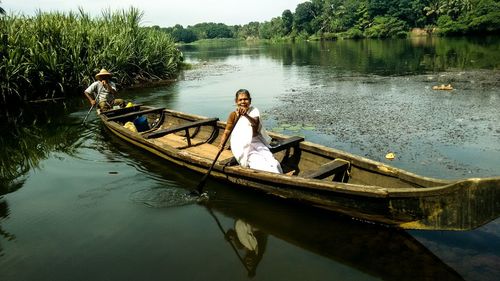 Senior couple sitting in boat on lake