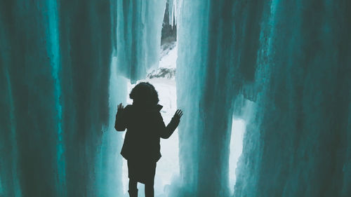 Woman standing in cave