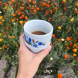 Midsection of person holding tea cup