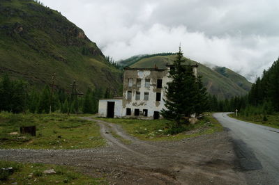 Road by mountain against sky