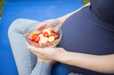 Low section of woman holding ice cream