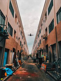 Street amidst buildings in city against sky