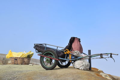 Rear view of man standing against blue sky