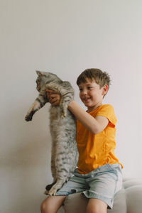 A cute boy hugs his cat. children and pets. concept of animals, friendship