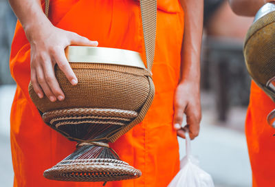 Midsection of monk with religious equipment