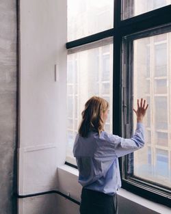 Woman standing by window