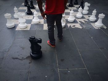 Low section of man standing on tiled floor