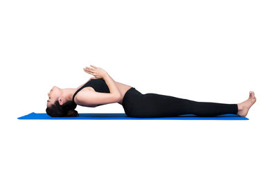 Woman lying down against white background