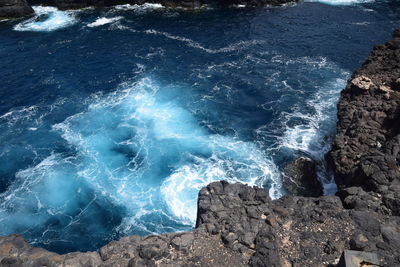 High angle view of rocks on sea shore