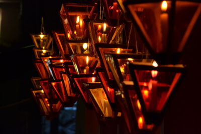 Close-up of illuminated burning candles in lanterns