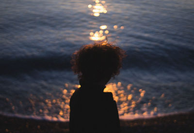 Silhouette woman standing against sky during sunset