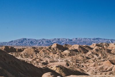 Scenic view of dramatic landscape against clear blue sky