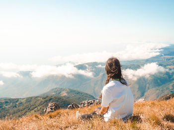 Rear view of man looking at mountains