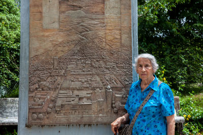 Senior woman tourist visiting the commemorative monument of the armero tragedy