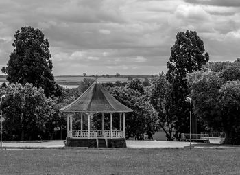 Gazebo by trees against sky