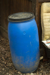 Close-up of blue metal container on wood