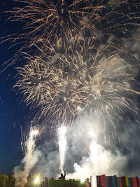 Low angle view of firework display at night