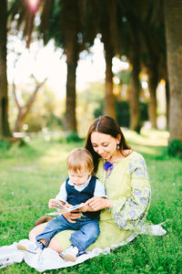 Mother and son sitting outdoors