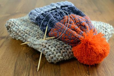 Close-up of knit hat on wooden table