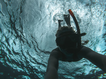 Low angle view of woman swimming in sea