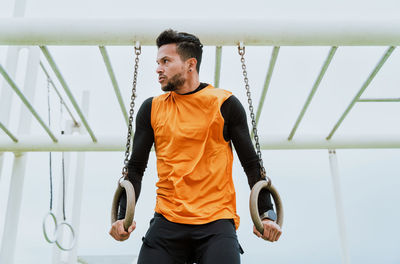 Low angle view of man exercising at park