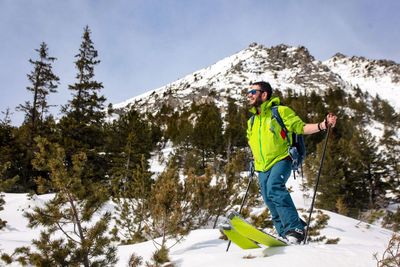 Man with umbrella on snowcapped mountain