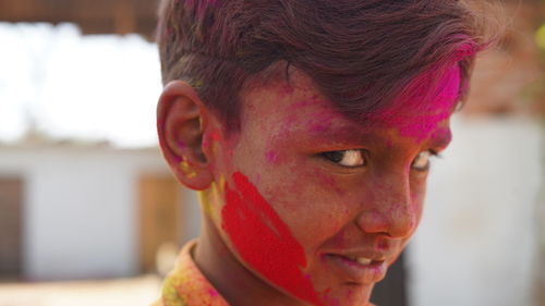 Cute indian little child playing holi. holi is colors festival in india