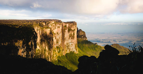 Scenic view of mountain against cloudy sky