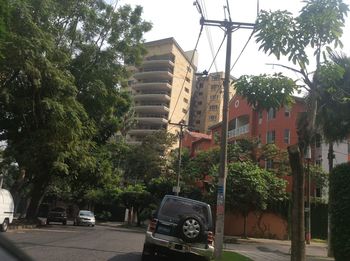 Vehicles on road against buildings