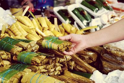 Midsection of person for sale at market stall