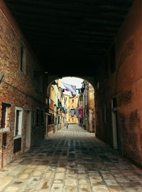 Empty alley along buildings