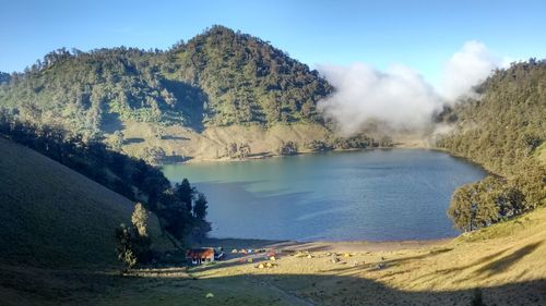 Scenic view part of semeru mountain call ranukumbolo lake and trees against sky in semeru, indonesia