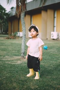 Portrait of boy standing on field