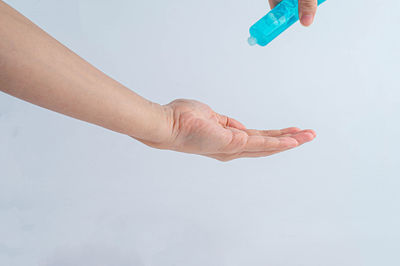 Close-up of person hand against white background