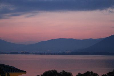 Scenic view of lake against romantic sky at sunset