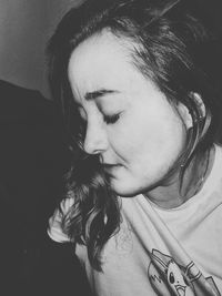 Close-up portrait of young woman looking away